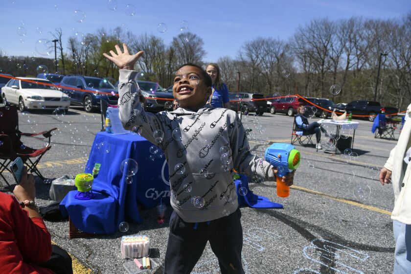 FILE - Blake Johnson, of Frackville, Pa., catches bubbles during the Stand Out and Shine: Autism Awareness Festival in Mar Lin, Pa., on Saturday, April 30, 2022. For the first time, autism is being diagnosed more frequently in Black and Hispanic children than in white kids in the U.S., the Centers for Disease Control and Prevention said Thursday, March 23, 2023. (Jacqueline Dormer/Republican-Herald via AP, File)