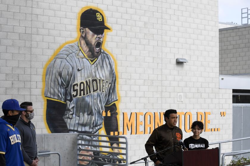 Muralists Paul Jimenez, left, and Signe Ditona speak at the unveiling a mural of San Diego Padres pitcher Joe Musgrove at Grossmont High School Wednesday, April 14, 2021 in La Mesa, Calif. (Photo by Denis Poroy)