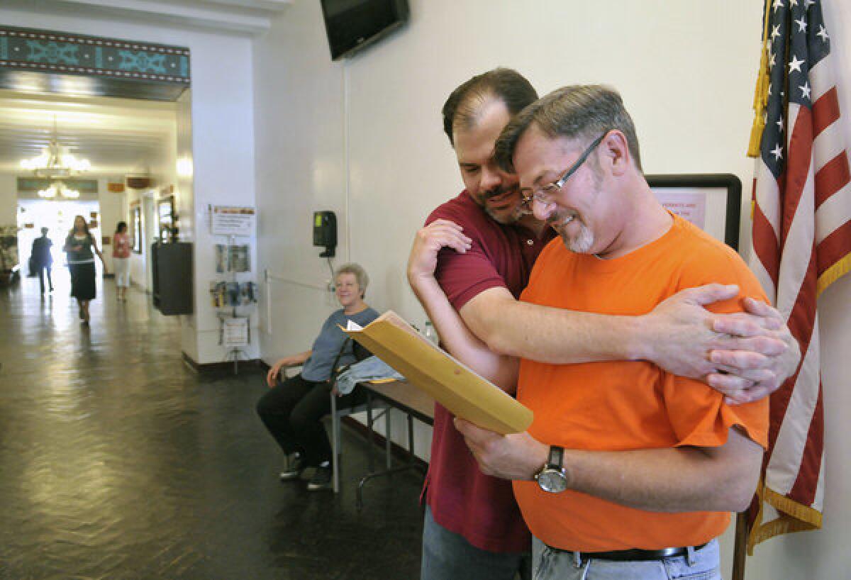 Todd Crawford, left, and Jimmy Huckaby embrace after receiving their marriage license at the Santa Fe County clerk's office in New Mexico.
