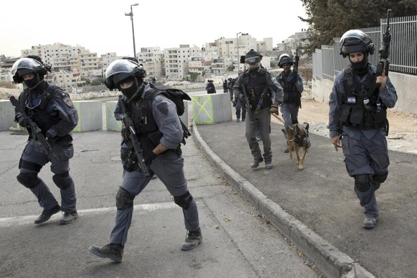 Israeli riot police officers operate in the Arab neighborhood of Issawiyeh in Jerusalem, Tuesday, Oct. 20, 2015. U.N. Secretary-General Ban Ki-moon will make a surprise visit to Israel and the Palestinian territories on Tuesday, in a high-profile gambit to bring an end to the monthlong wave of violence that has plagued the region. (AP Photo/Ariel Schalit)