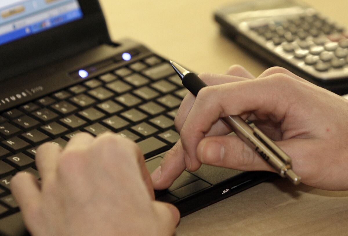 A person types on a laptop. Legislation could end Bureau of Prisons' unjust monitoring of inmate-attorney emails. 