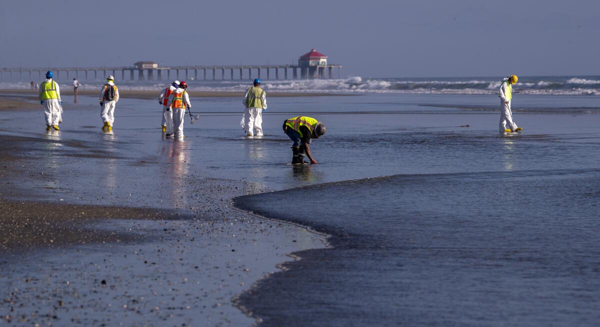 Crews clean oil from a beach
