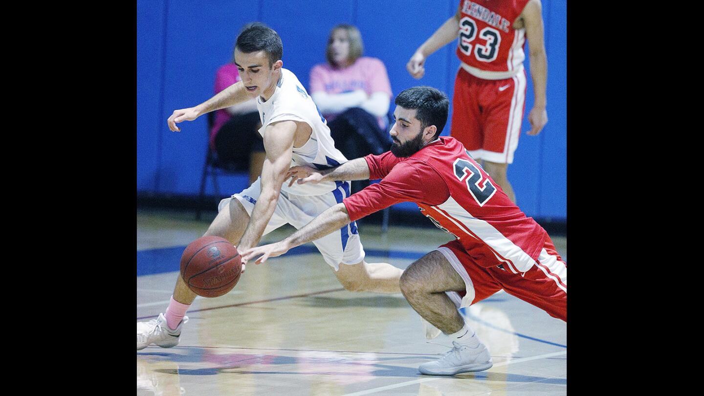 Burbank's Sevak Mkrtchyan steals the ball with Glendale's Dante Terteryan diving to get it back in a Pacific League boys' basketball game at Burbank High School on Friday, January 26, 2018.