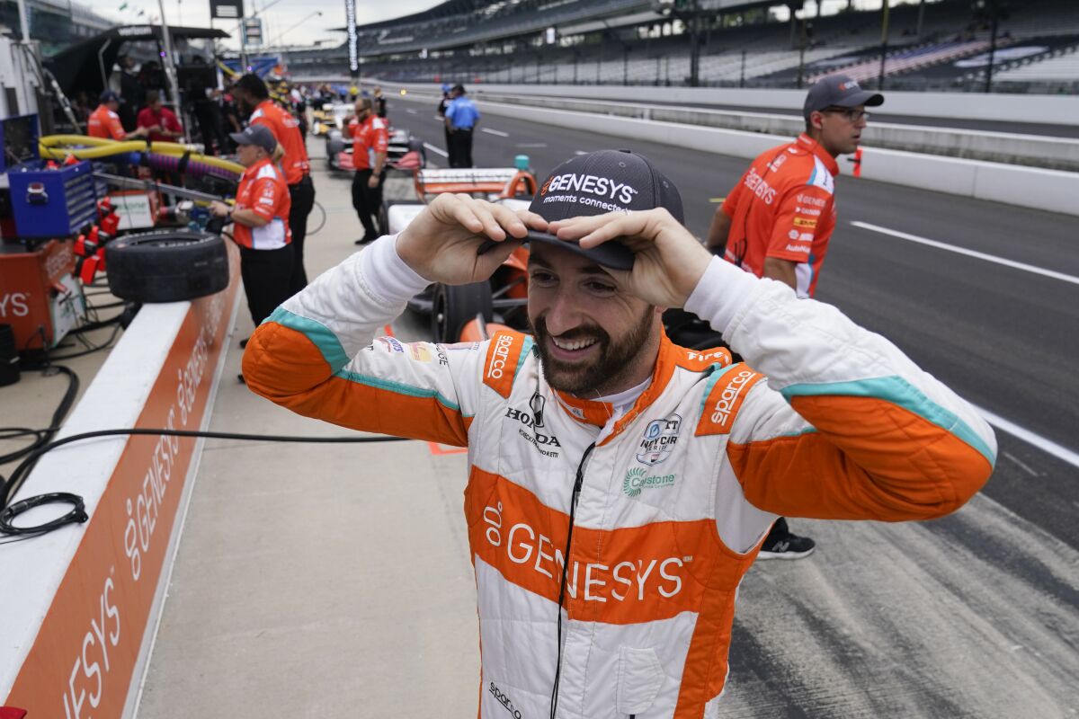 FILE - James Hinchcliffe, of Canada, waits in the pits before a practice session for the IndyCar auto race at Indianapolis Motor Speedway, Friday, Aug. 13, 2021, in Indianapolis. Hinchcliffe, one of IndyCar's most popular drivers, said Tuesday, Dec. 14, he's stepping away from full-time racing in the series. (AP Photo/Darron Cummings, File)