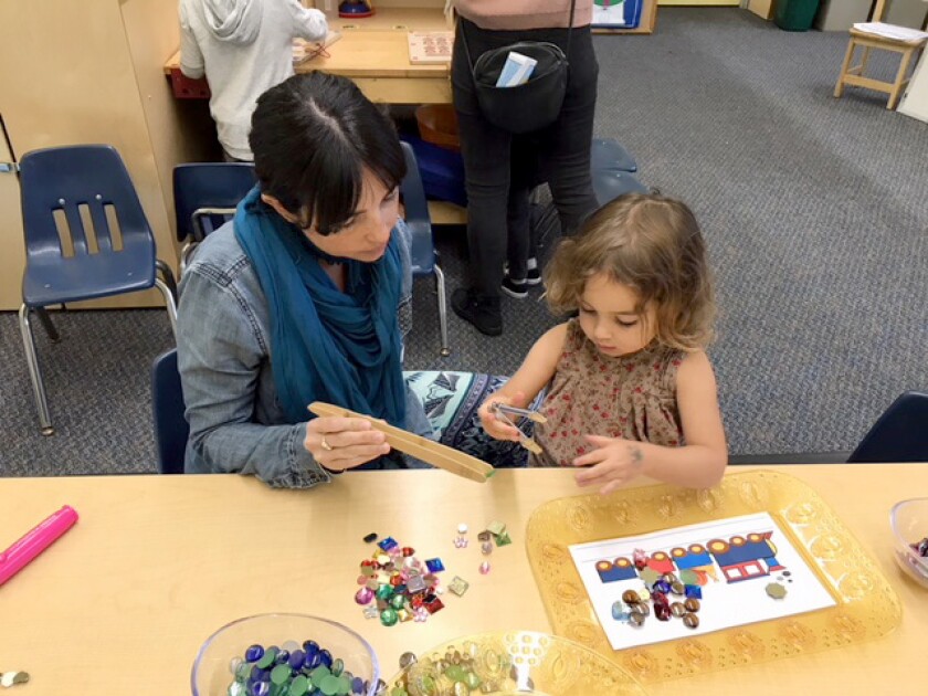 A student and parent from the Laguna Beach Unified School District participate in a Passport to Learning activity.
