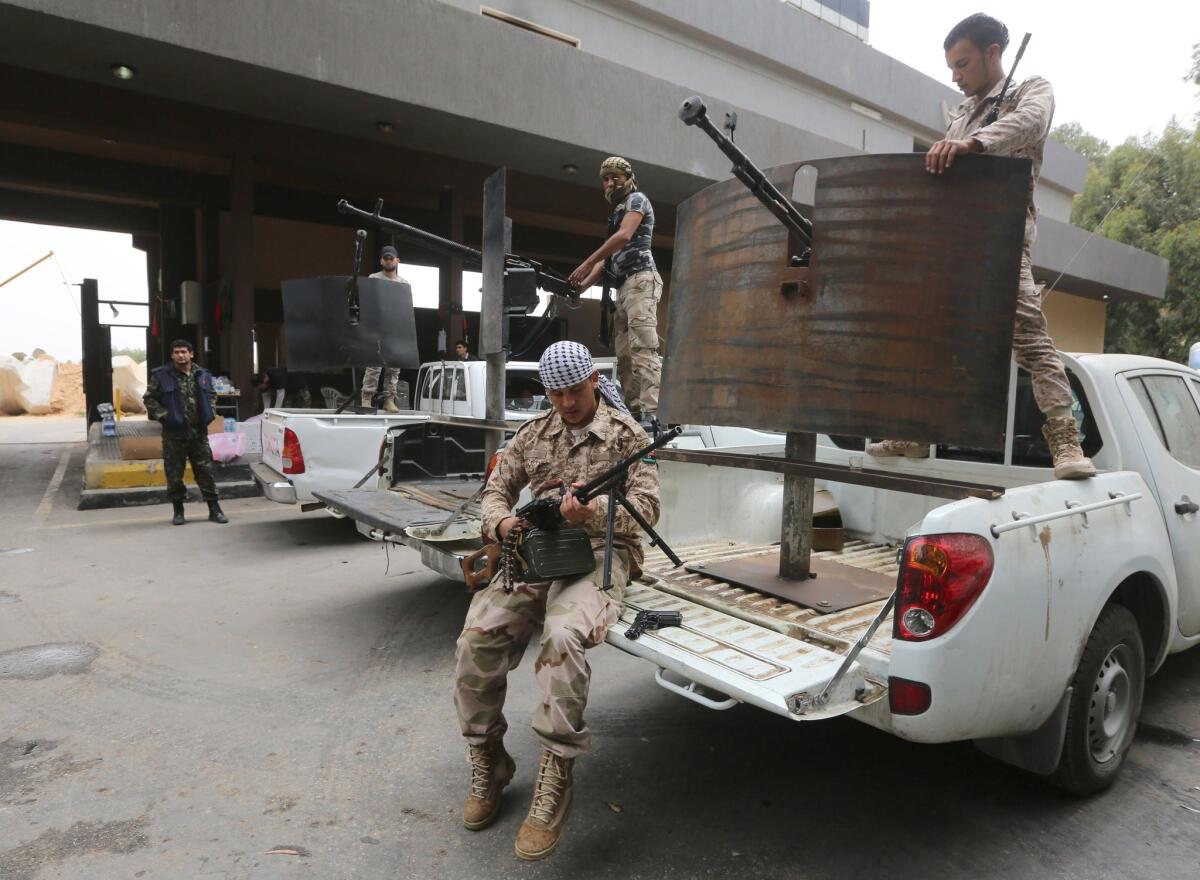 Former rebel fighters who are now integrated into the Libyan army are seen May 19 guarding the western entrance of Tripoli, the capital.