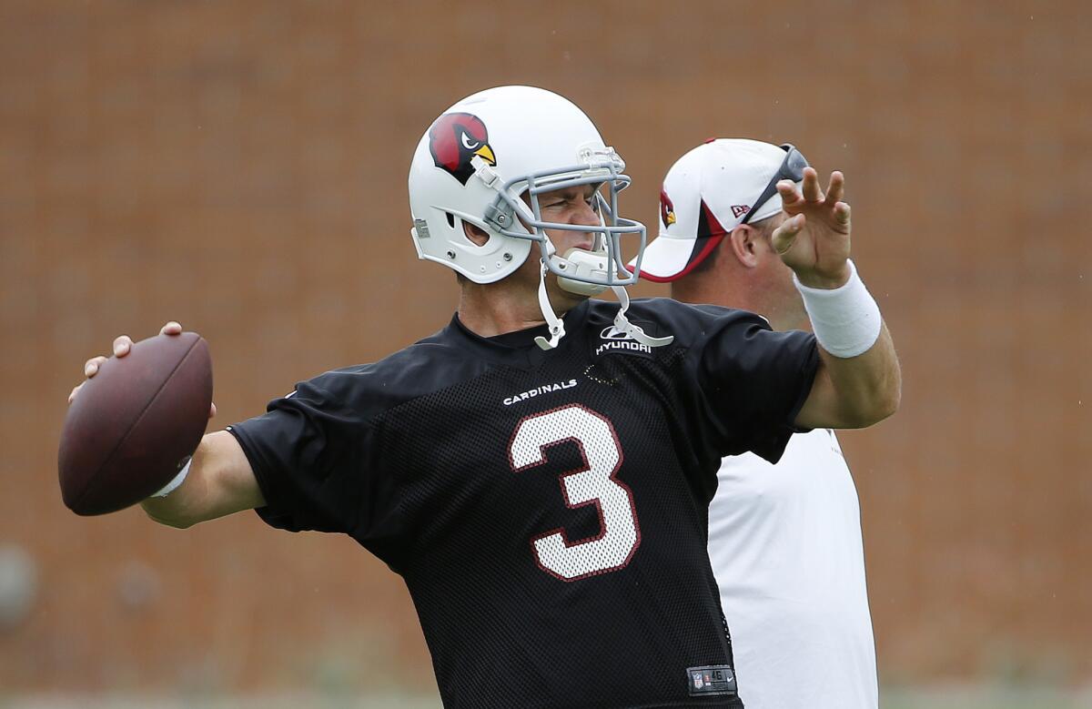 Cardinals quarterback Carson Palmer throws a pass as he warms up during an organized team activity in June.