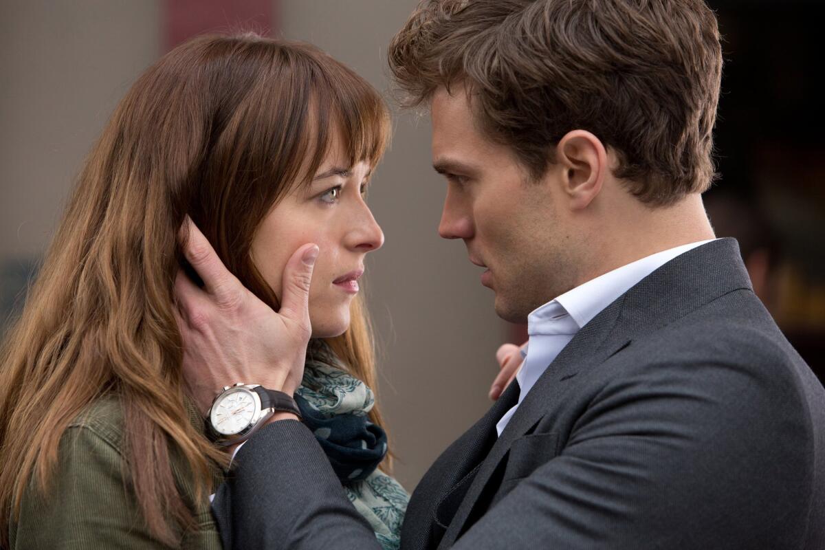 Dakota Johnson, left, and Jamie Dornan in a scene from "Fifty Shades of Grey," which broke box office records for Presidents Day weekend.