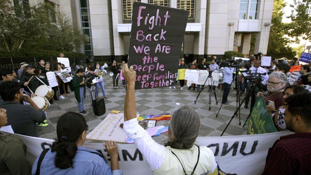 Protesters demonstrate in 2018 outside the federal courthouse in Sacramento, where a judge heard arguments over the Trump administration's bid to block three California immigrant-sanctuary laws. A federal appeals panel heard arguments in the case Wednesday.