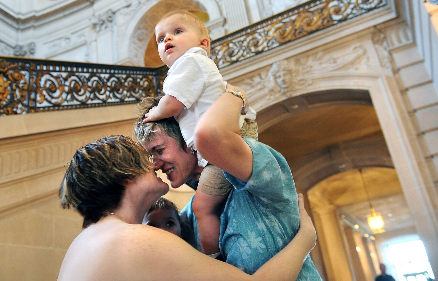 Rachael Hadley left, and her new wife Kim celebrate with their children Sidney, left, and Phin at City Hall while getting married Saturday in San Francisco.