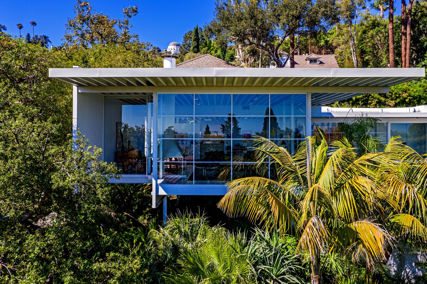 Maroon 5 guitarist James B. Valentine is seeking $3.785 million for a pristine Midcentury Modern-style home in Los Feliz. The striking residence, designed by Neil A. Johnson and built in 1960, was extensively restored by Mark Haddawy during Valentine's decade-plus of ownership. The single-story house features such modernist staples as terrazzo floors, beamed ceilings and walls of floor-to-ceiling windows. A suspended fireplace is an attention-grabber in the living room. The 2,100-square-foot house also has a garden-view dining room, an updated kitchen, three bedrooms and two bathrooms.