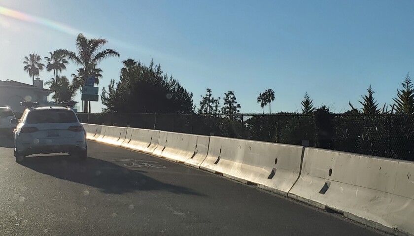 This white K-rail on Torrey Pines Road will be replaced with a guardrail.