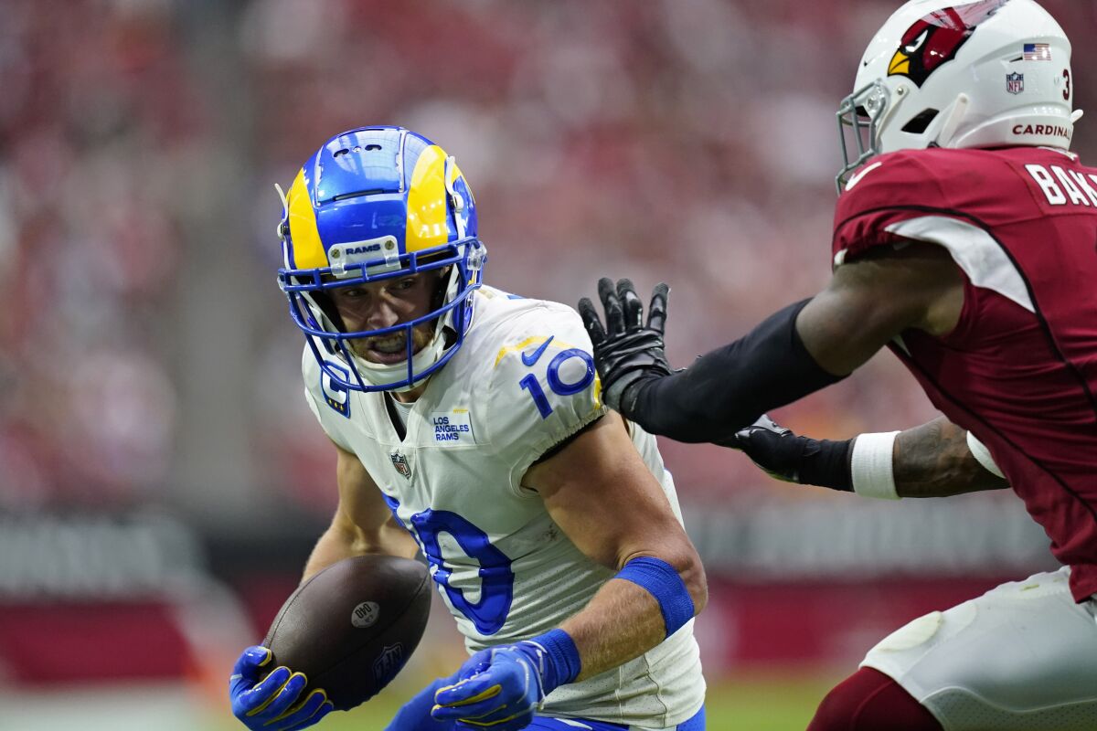 Rams wide receiver Cooper Kupp (10) makes a catch against Cardinals safety Budda Baker.