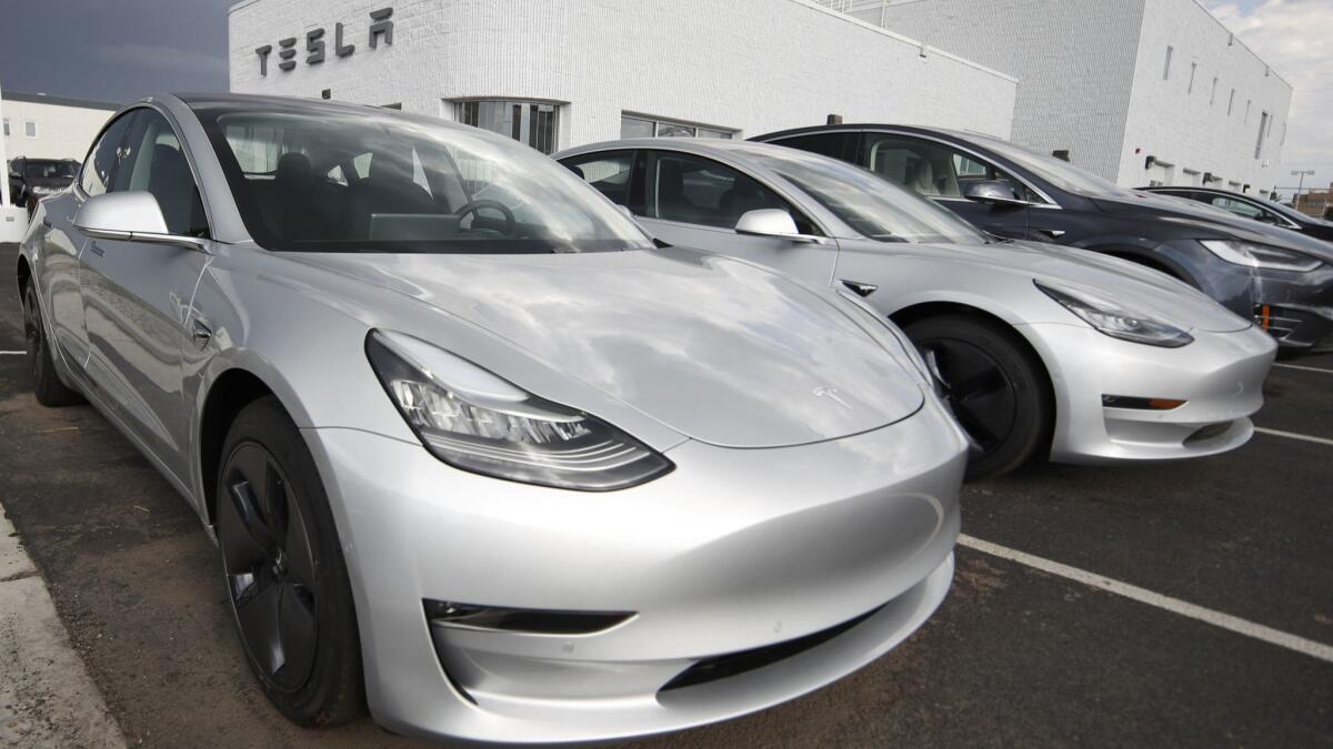 Model 3 sedans are displayed in a Tesla store lot in Colorado in 2018.