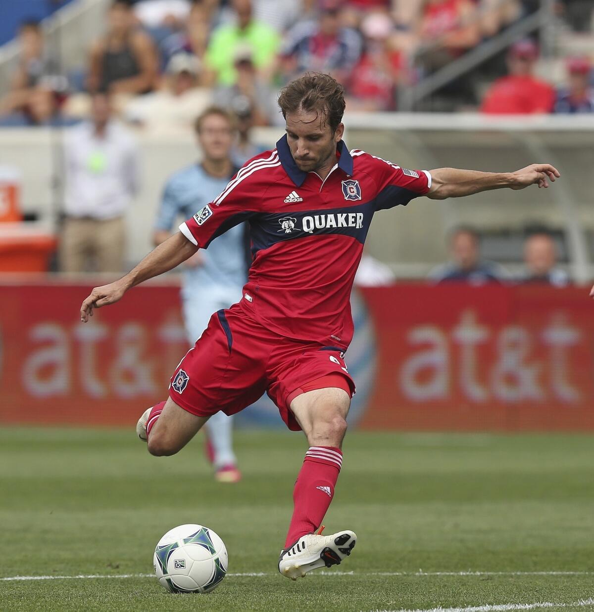 Mike Magee #9 of the Chicago Fire scores a first half goal against Sporting Kansas City during an MLS match at Toyota Park on July 7, 2013 in Bridgeview, Illinois. Sporting Kansas City defeated the Fire 2-1.