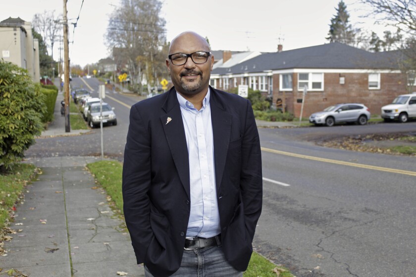 Portland City Councilman Mingus Mapps poses in front of his house in southwest Portland, Ore., on Nov. 16, 2021. Mapps, who took office in January, has become a key voice nudging Portland to a more centrist position on police funding as Portland grapples with its identity in the post-protest era. (AP Photo/Gillian Flaccus)