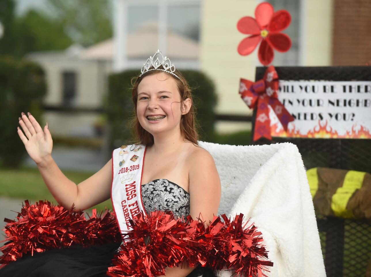 Kerrigan Spenner, Miss Fire Prevention Carroll County, waves to people during the parade at the Manchester Volunteer Fire Company carnvial on Tuesday, July 2.