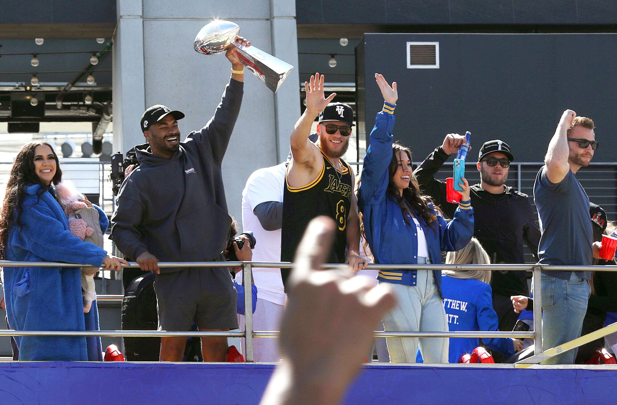 Rams players and their families celebrate during the team's victory parade in Los Angeles. At right is Rams coach Sean McVay.