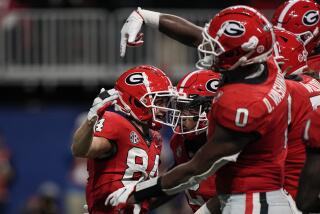 Georgia wide receiver Ladd McConkey (84) celebrates a touchdown with his teammates in the first half of the Southeastern Conference championship NCAA college football game against LSU, Saturday, Dec. 3, 2022, in Atlanta. (AP Photo/Brynn Anderson)