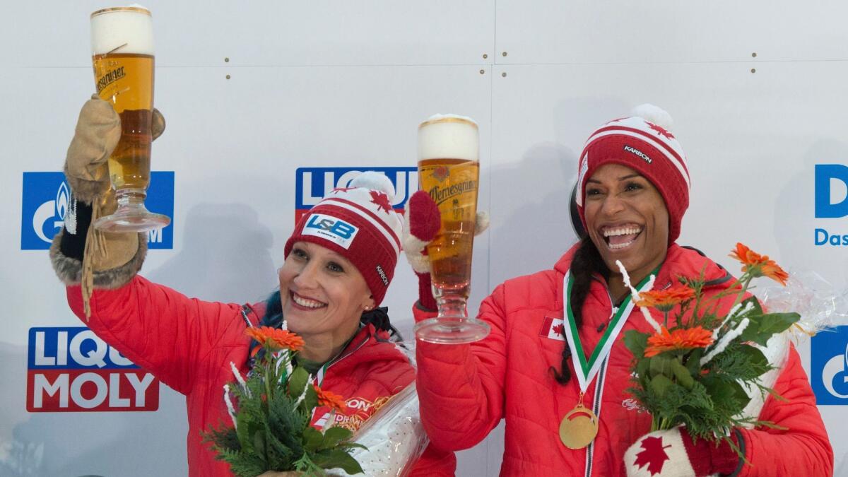 Kaillie Humphries, left, celebrates a victory with Phylicia George.