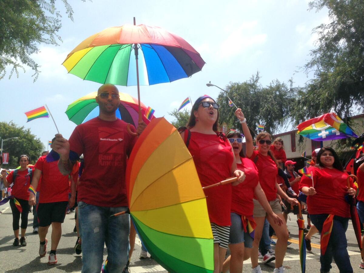 Kevin Calhoun, left, and Dana Varga march in the 2013 LA Pride Parade in West Hollywood.
