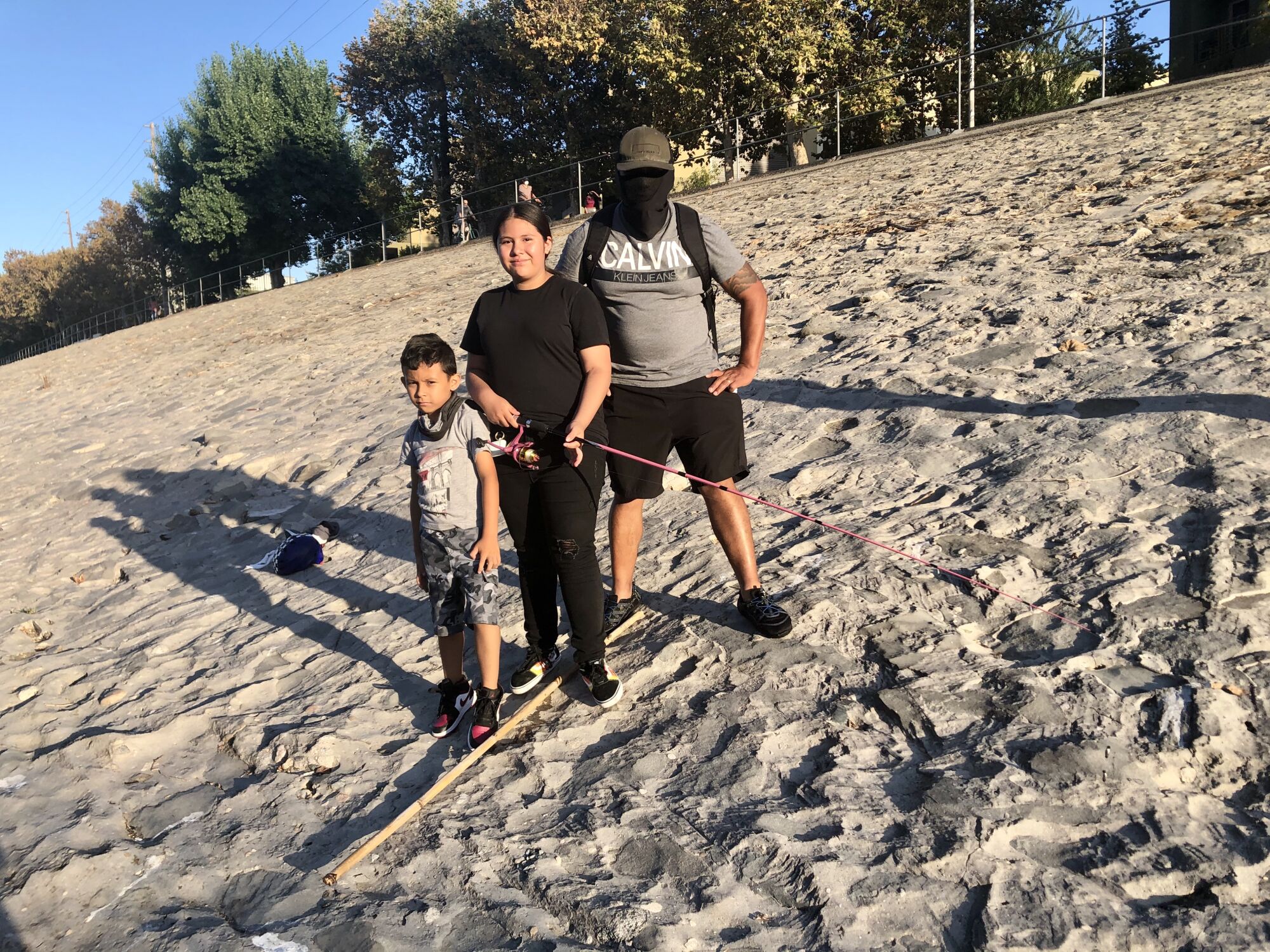 The Reyes family fishes at the L.A. River on a warm afternoon.