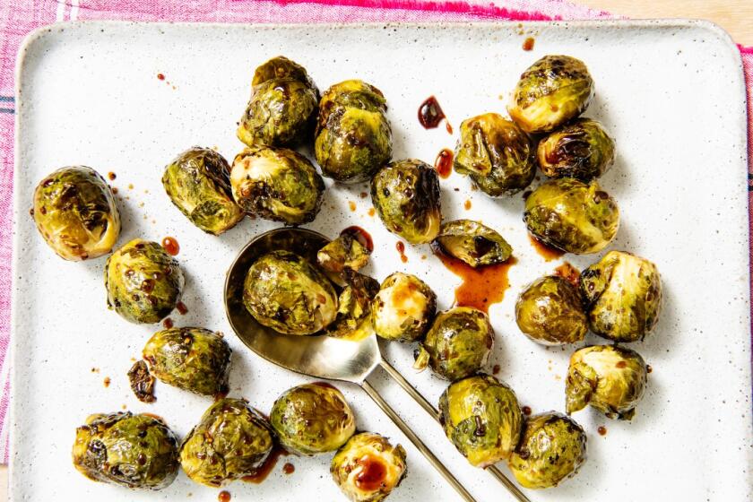 Brussels sprouts are left whole and glazed with a yakitori-style sauce. Prop styling by Nidia Cueva.