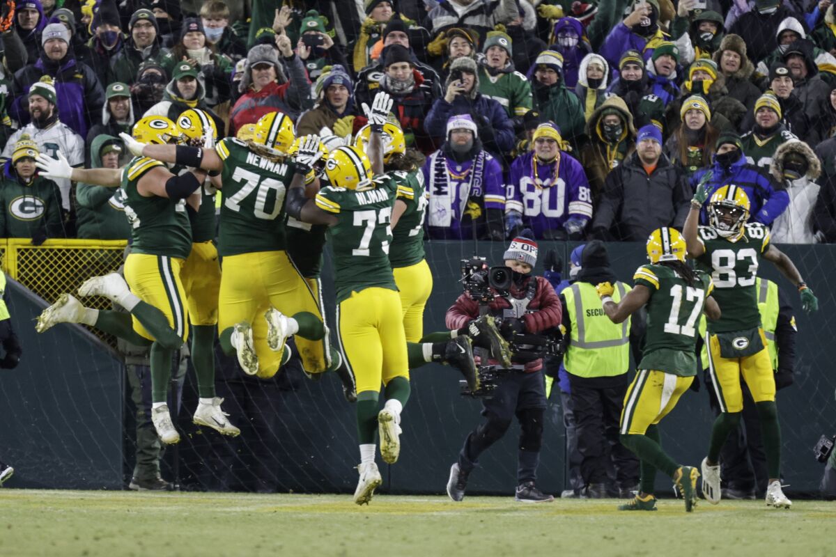The Green Bay Packers offensive line celebrates a touchdown catch by Davante Adams during the first half of an NFL football game against the Minnesota Vikings Sunday, Jan. 2, 2022, in Green Bay, Wis. (AP Photo/Matt Ludtke)