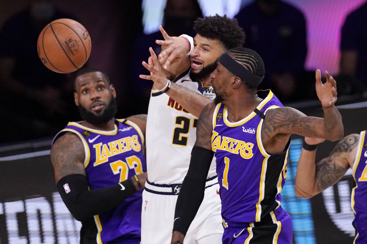 Nuggets guard Jamal Murray battles with the Lakers' LeBron James (23) and Kentavious Caldwell-Pope (1) during Game 5.