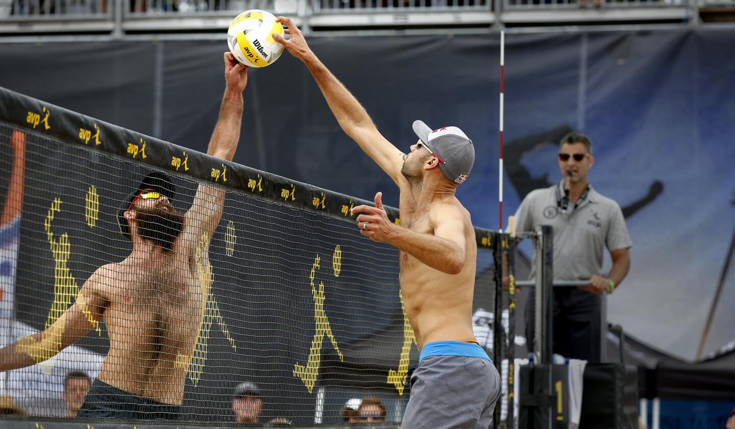 Phil Dalhousser, right, and Maddison McKibbin battle for a tip during the opening round of the Huntington Beach Open. Dalhausser and teammate Nick Lucena defeated the McKibbin brothers.
