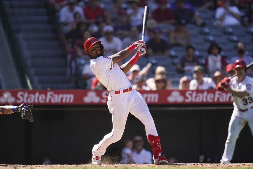Los Angeles Angels' Jo Adell hits a home run during the sixth inning of a baseball game against the Texas Rangers Sunday, Sept. 5, 2021, in Anaheim, Calif. Jack Mayfield (9) also scored. (AP Photo/Ashley Landis)