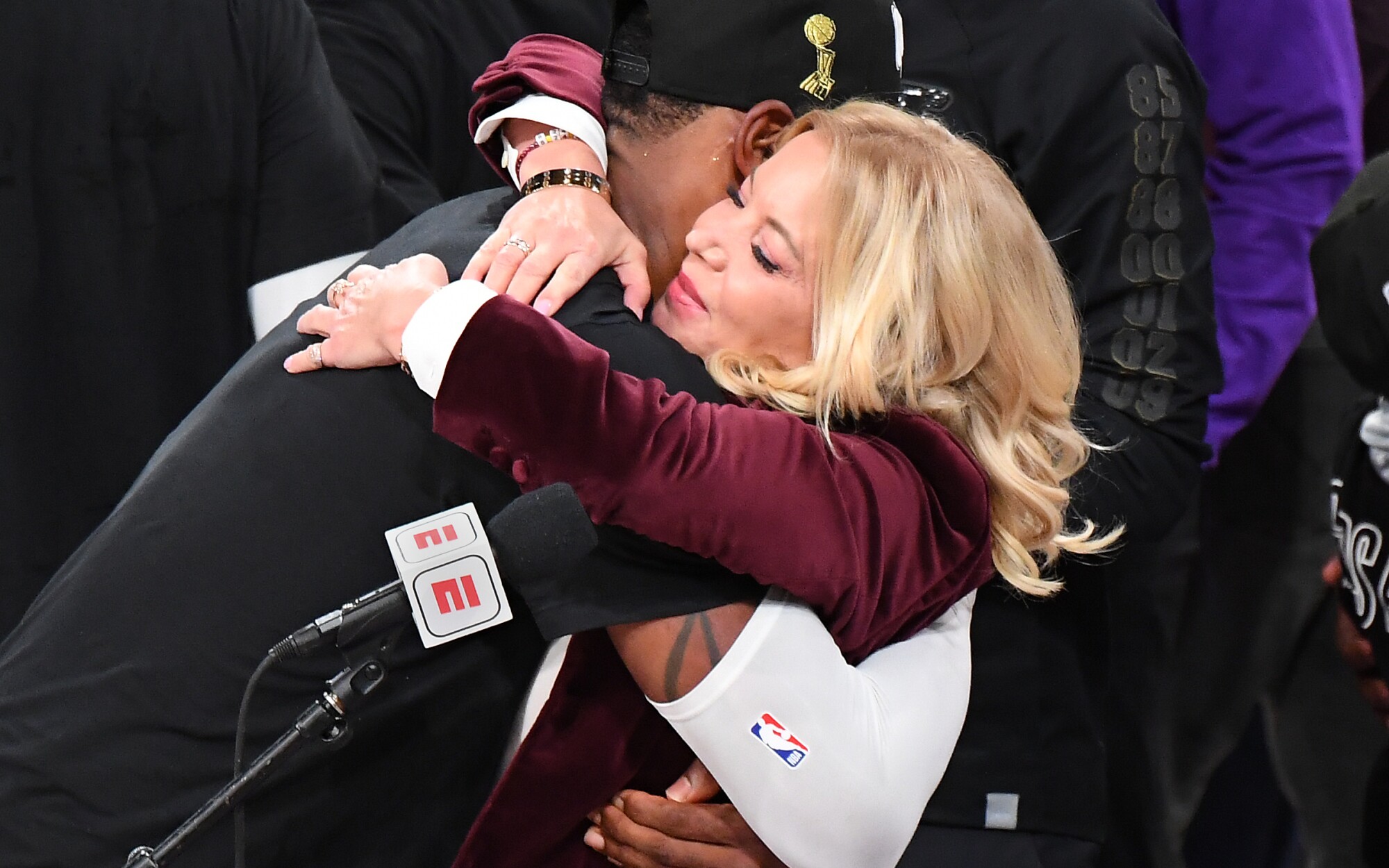 Lakers co-owner Jeanie Buss gets a hug from LeBron James after the team won the NBA championship.