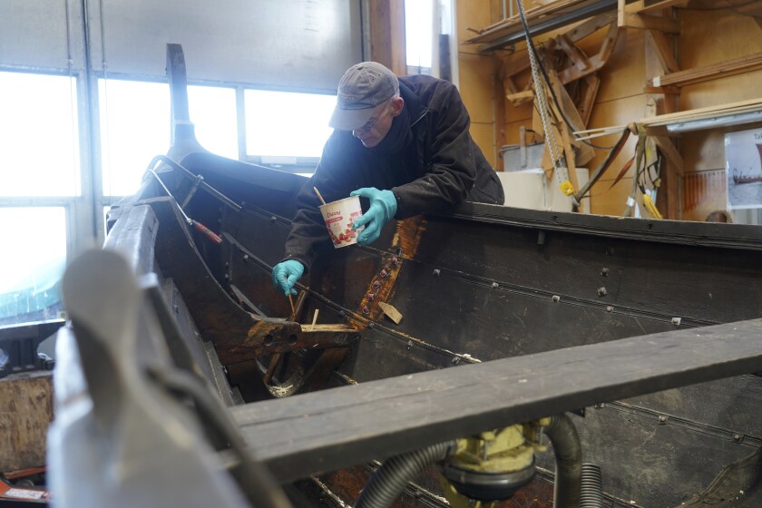 A man repairs a 10-meter wooden row boat, built in the Nordic clinker boat tradition, at the Viking Ship Museum's boatyard. Roskilde, Denmark, Monday, Jan. 17, 2022. For thousands of years, wooden sail boats, best known for having been in use during the Viking-era, allowed the peoples of northern Europe to spread trade, influence and -- in some cases war — across the seas and rivers. In December, UNESCO, the U.N.’s culture agency, added the “clinker’ boat traditions to its list of “Intangible Cultural Heritage,” the result of the first joint nomination from the whole Nordic region. (AP Photo/James Brooks)