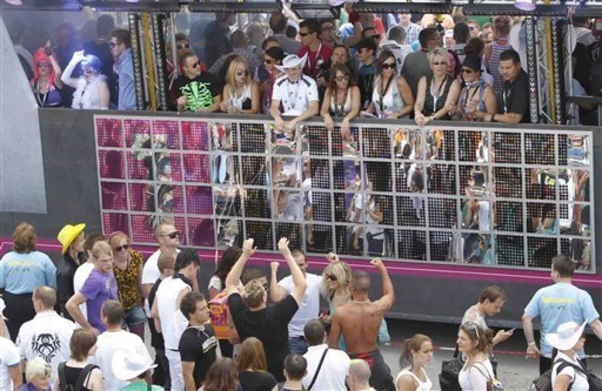 People celebrate this year's techno-music festival "Loveparade 2010" in Duisburg, Germany, on Saturday, July 24, 2010. German police say that 10 people were killed and 15 others injured when mass panic broke out in a tunnel at the Love Parade.(AP Photo/dapd/Photo/Hermann J. Knippertz)