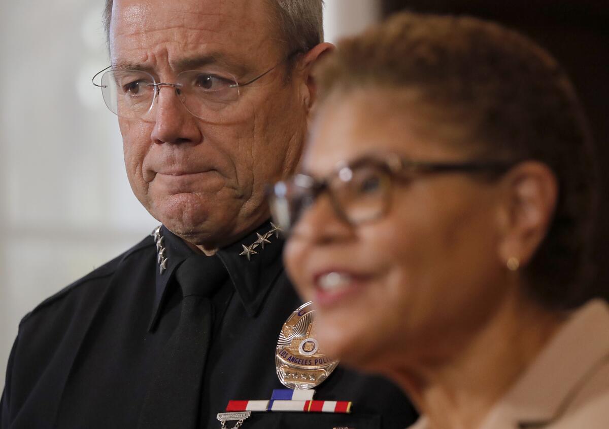 Los Angeles Mayor Karen Bass and LAPD Chief Michel Moore stand near each other.