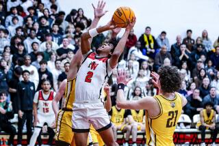 Robert Hinton of Harvard-Westlake goes up for shot against Crespi defenders.