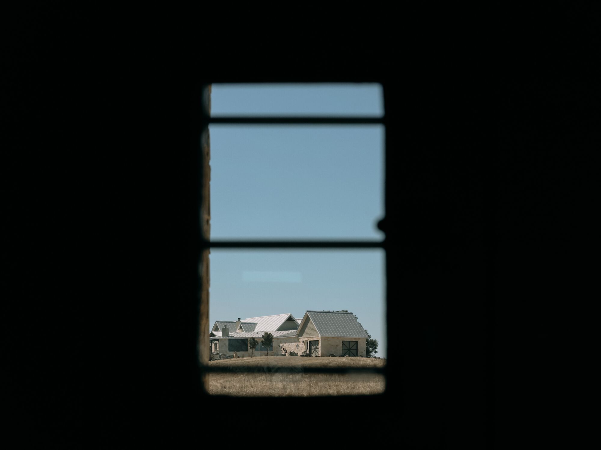 A house can be seen from a window.