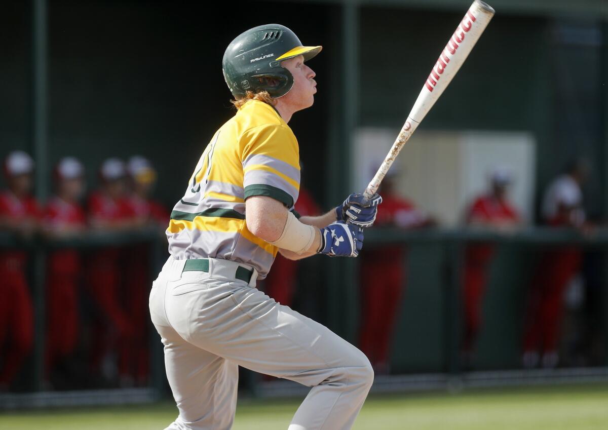Edison High's Blake Morton hits a solo homer in the second inning of a Surf League game at Los Alamitos on Friday.