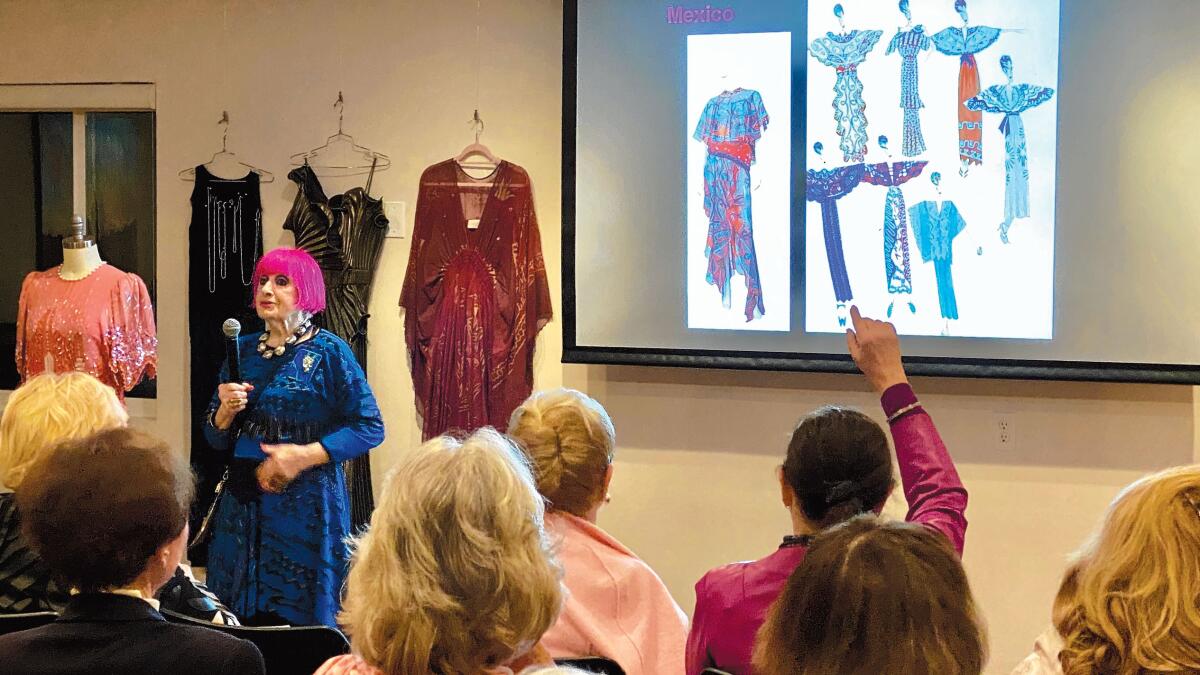 Fashion designer Zandra Rhodes takes questions and explains her hand-printed fabric process using sample gowns from many of her collections at La Jolla Community Center's Distinguished Speaker Series on March 3, 2020.