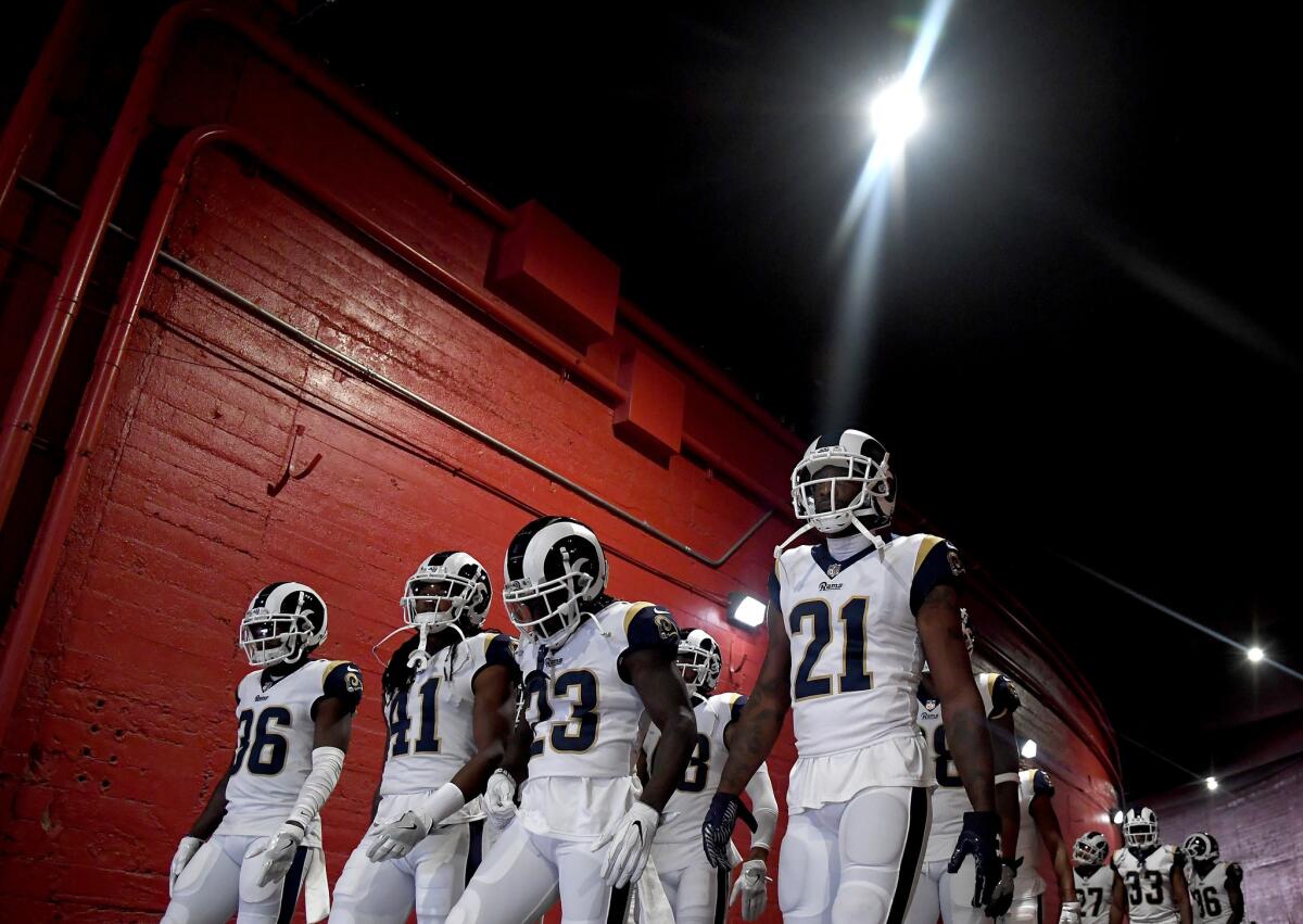 Aqib Talib (21), Nickell Robey-Coleman (23), Marqui Christian (41) and Dominique Hatfield (36) head to the field before a preseason game against Houston at the Coliseum.