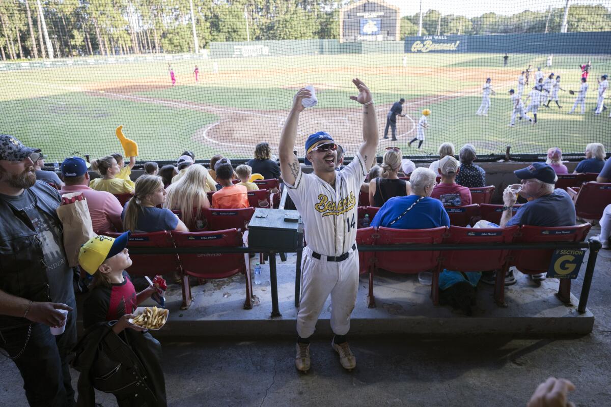 Savannah Bananas catcher Vinny Rauso tries to get fans to cheer before throwing a free T-shirt to the loudest section.