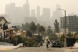 LOS ANGELES, CA - SEPTEMBER 14: Smoke and ash from the Bobcat fire burning in the Angeles National Forest have blanketed the region for a week, contributing to poor air quality which nearly obscures the tall buildings of downtown Los Angeles September 14, 2020. Current air quality readings are considered unhealthy for sensitive groups according to the Environmental Protection Agency. The bobcat fire is one of more than 25 fires burning in California creating a plume that spanned more than 1,000 miles. Downtown on Monday, Sept. 14, 2020 in Los Angeles, CA. (Al Seib / Los Angeles Times