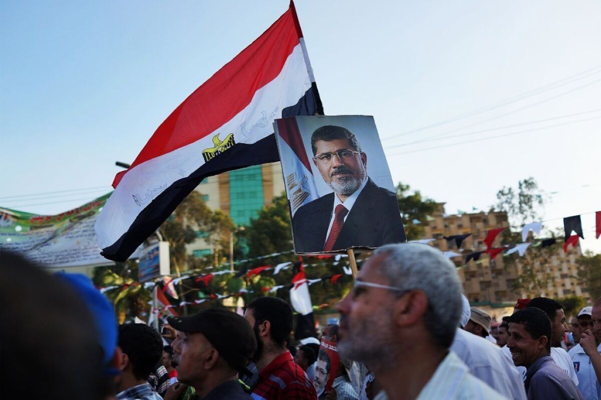 The Egyptian interim government has declared the Mohamed Morsi-led Muslim Brotherhood a terrorist organization. Above, supporters of ousted President Morsi hold a rally in Cairo on July 11.