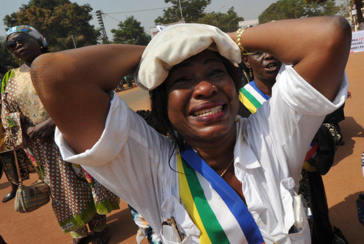 A member of the Central African Republic's national assembly cries while praying Friday during a women's protest in Bangui, the capital, against the conflict in their country.