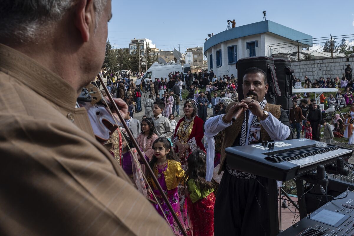 Iraqi Kurds celebrate Nowruz, a Persian New Year, in Sulaimaniyah, Iraq, Monday, March 20, 2023. The Kurdish in Iraq region won de facto self-rule in 1991 when the United States imposed a no-fly zone over it in response to Saddam's brutal repression of Kurdish uprisings. With American invasion 20 years ago much of Iraq fell into chaos, as occupying American forces fought an insurgency and as multiple political and sectarian communities vied to fill the power vacuum left in Baghdad. But the Kurds, seen as staunch allies of the Americans, strengthened their political position and courted foreign investments. (AP Photo/Hawre Khalid, Metrography)