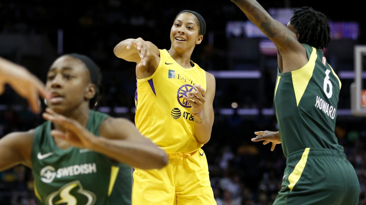Sparks star Candace Parker passes to a teammate during Sunday's win over the Seattle Storm.