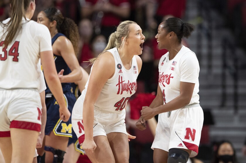 Nebraska's Alexis Markowski (40) and Sam Haiby (4) celebrate after drawing a foul and making the basket against Michigan during the first half of an NCAA college basketball game Tuesday, Jan. 4, 2022, in Lincoln, Neb. (AP Photo/Rebecca S. Gratz)