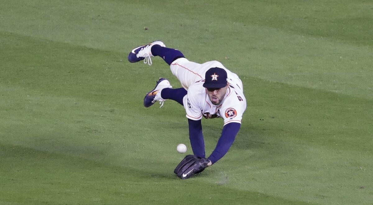 The Astros' George Springer can't come up with a ball hit by the Dodgers' Cody Bellinger during the seventh inning.