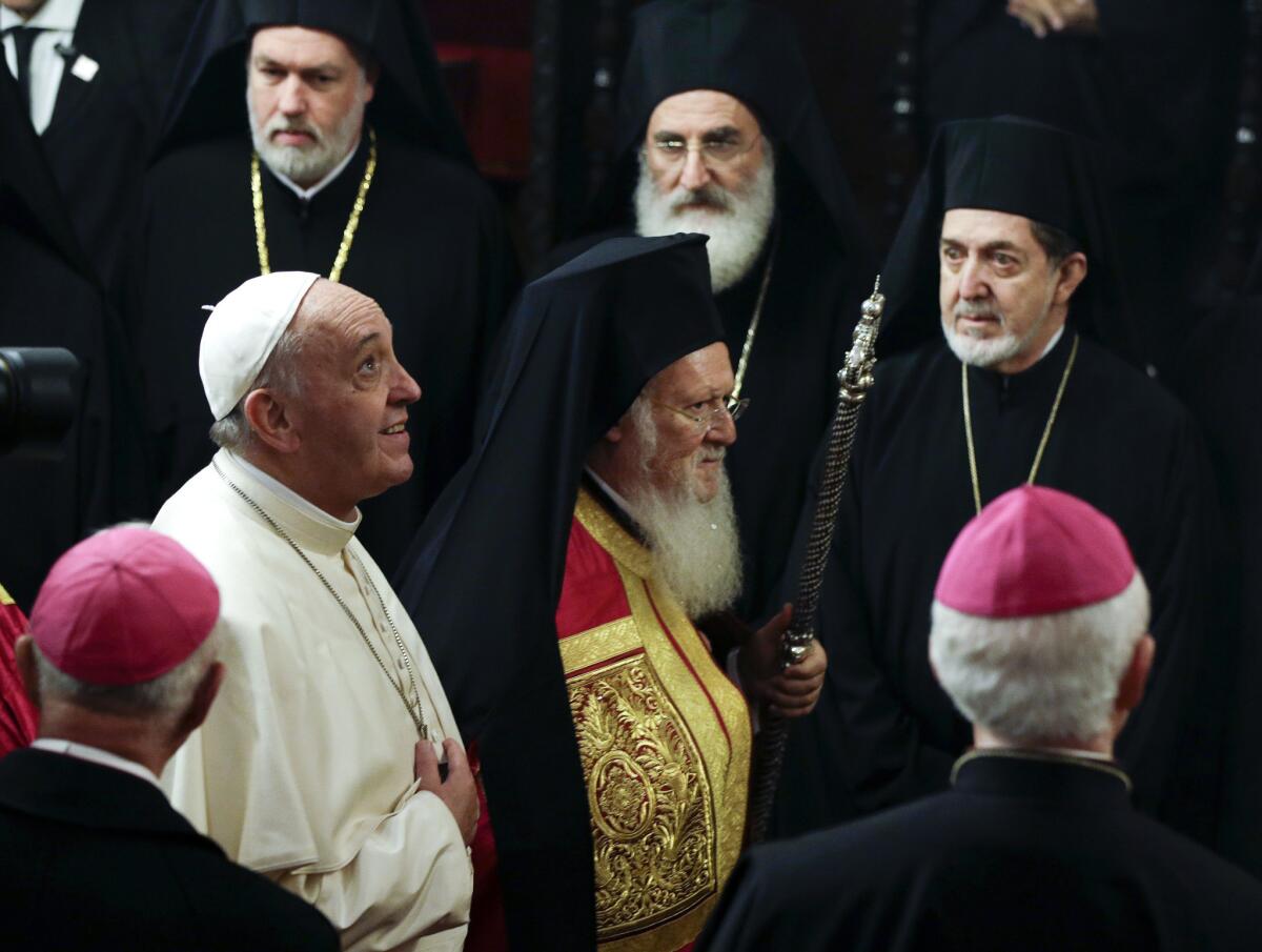 In 2014, Pope Francis, left, arrives with Ecumenical Patriarch Bartholomew I to attend an ecumenical prayer service in Istanbul, Turkey. On Saturday, both religious leaders will visit the Greek island of Lesbos to voice their solidarity with the refugees and migrants who have streamed into Europe fleeing war, poverty and persecution.