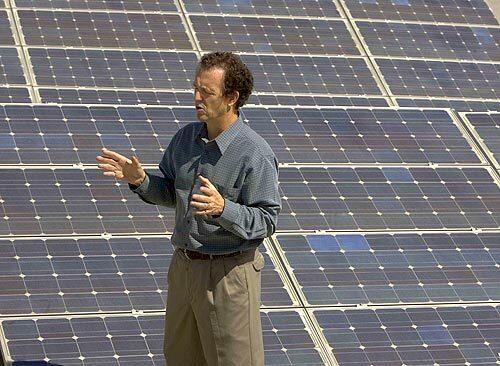 Gary Gerber, founder and president of Sun Light & Power, stands on his offices roof in Berkeley. When he first began the firm in the 1970s, he had to support himself by selling cheese.